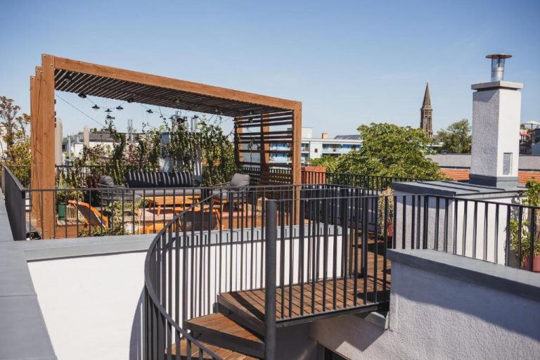 a balcony with a gate and stairs on a building at The Circus Apartments in Berlin 768x512