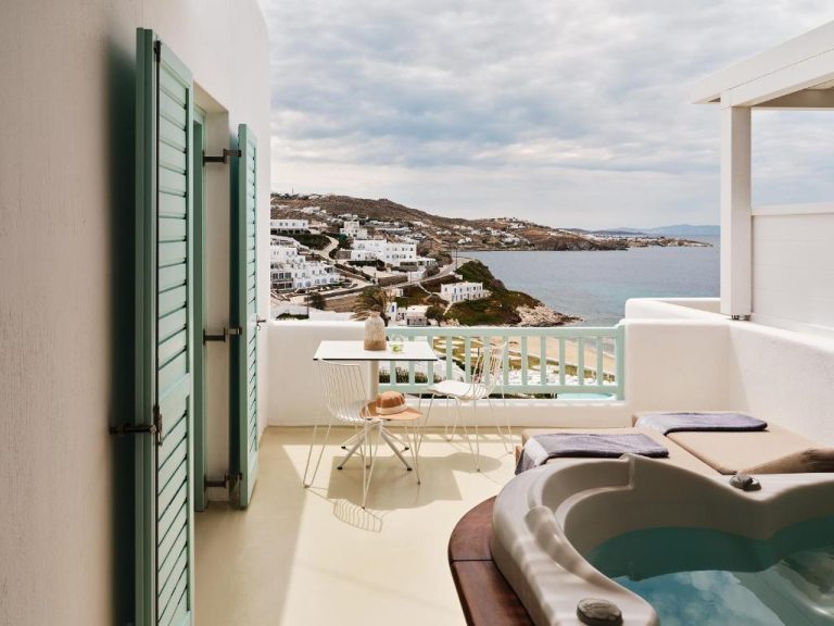 a balcony with a tub and a view of the ocean at BillCoo Mykonos The Leading Hotels of the World in Mikonos 768x576