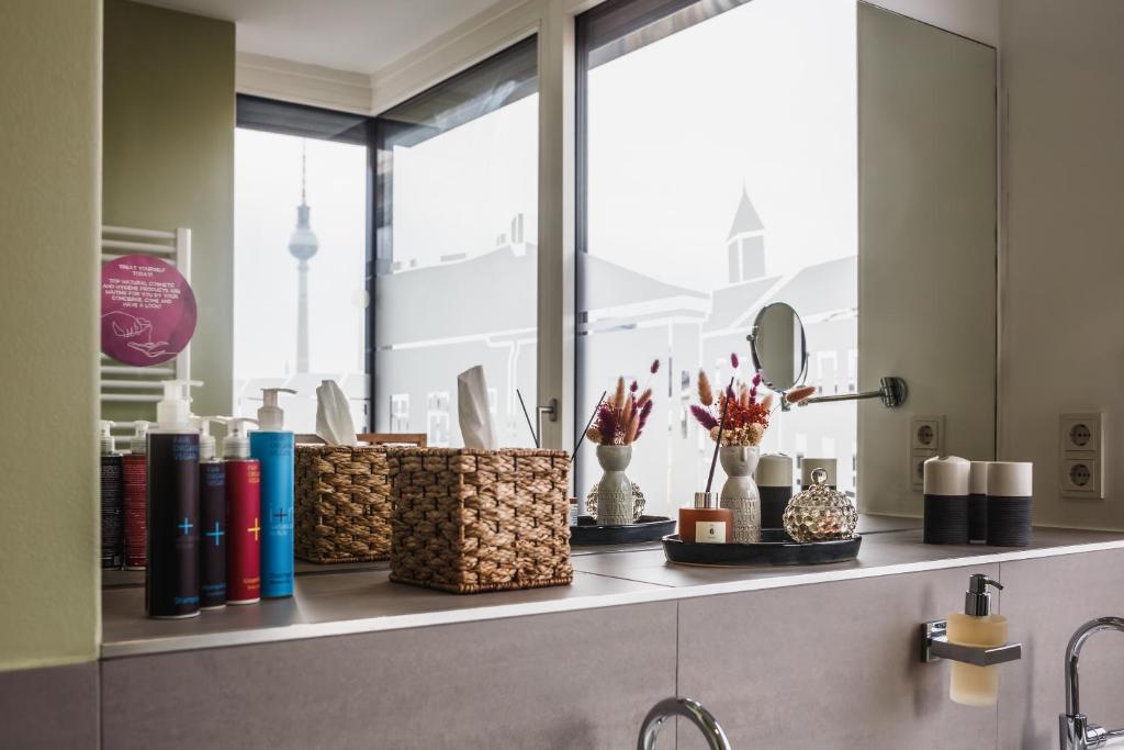 a bathroom counter with baskets and a window at The Circus Apartments in Berlin