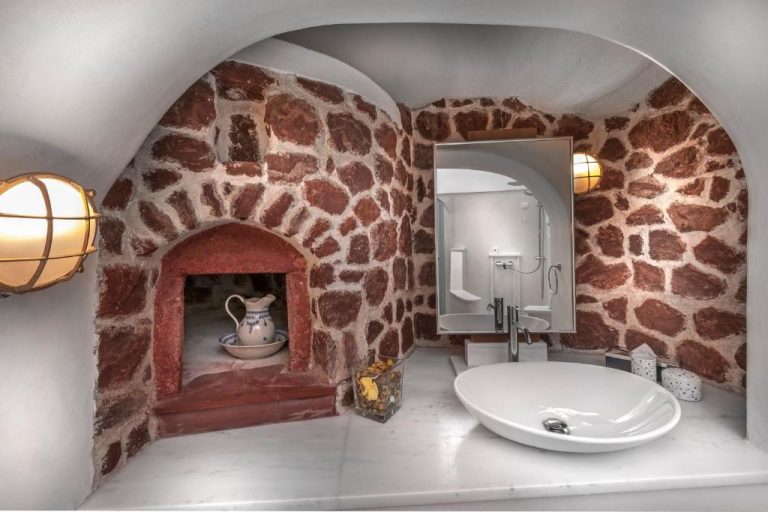 a bathroom with a fake giraffe wall and a sink at Aigialos Luxury Traditional Settlement in Fira 768x512