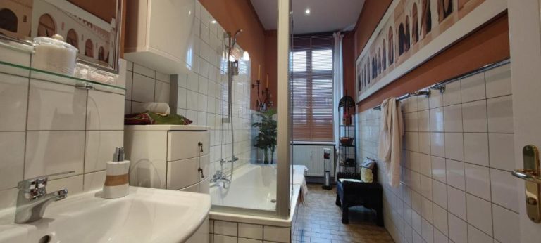 a bathroom with a sink and a bath tub at Boutique Hotel Mittendrin Berlin in Berlin 768x346