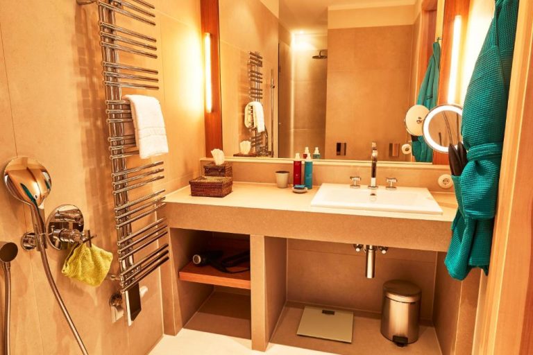 a bathroom with a sink and a mirror at Orania.Berlin in Berlin 768x512