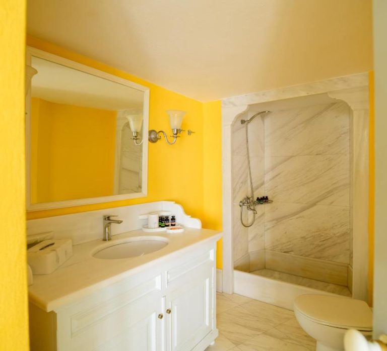 a bathroom with a sink and a shower at Aigialos Luxury Traditional Settlement in Fira 768x698