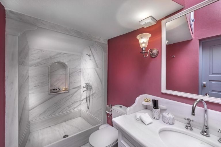 a bathroom with a toilet and a sink and a shower at Aigialos Luxury Traditional Settlement in Fira 768x512