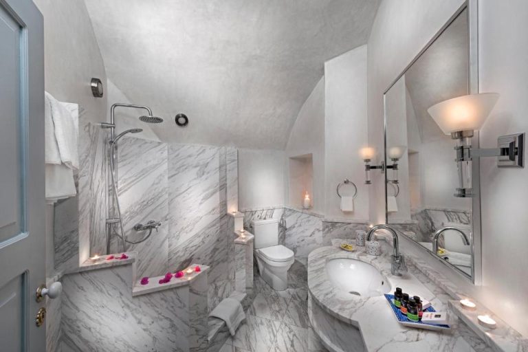a bathroom with a tub and a toilet and a sink at Aigialos Luxury Traditional Settlement in Fira 768x512