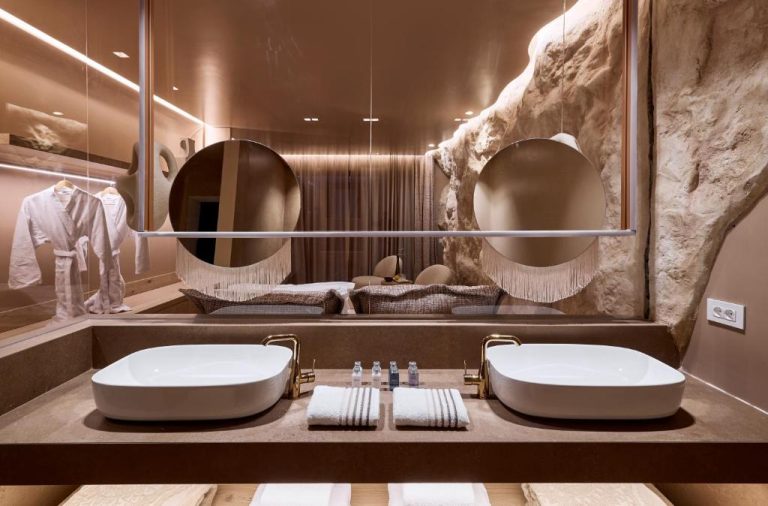 a bathroom with two sinks and two mirrors at Ethereum Luxury Suites a member of Mykonos Highlights in Mikonos 768x506