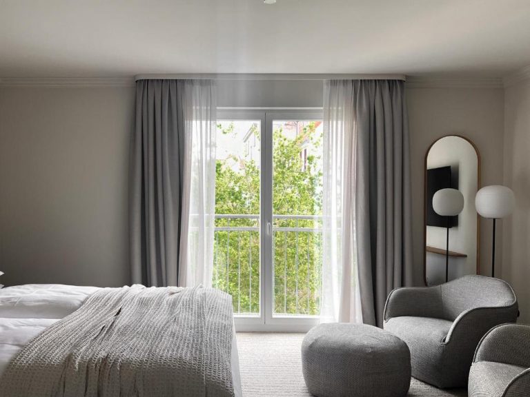 a bedroom with a bed and a chair and a window at ADELANTE Boutique Hotel in Berlin 768x576