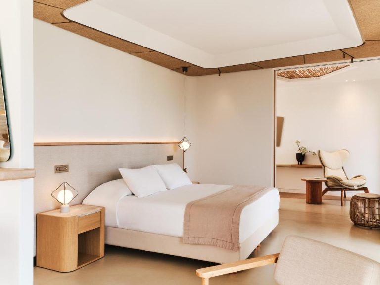 a bedroom with a bed and a chair at BillCoo Mykonos The Leading Hotels of the World in Mikonos 768x576