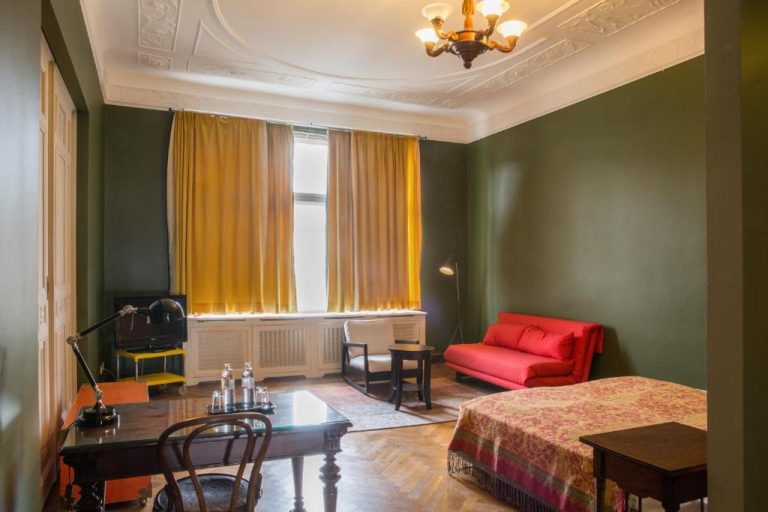 a bedroom with a bed and a desk and a red chair at Hotel Art Nouveau am Kurfurstendamm in Berlin 768x512