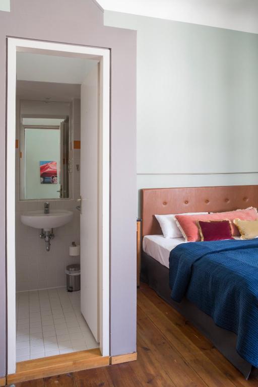 a bedroom with a bed and a sink at Hotel Art Nouveau am Kurfurstendamm in Berlin