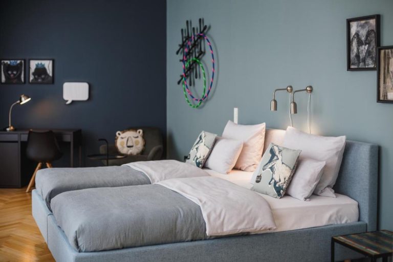 a bedroom with a bed with pillows on it at The Circus Apartments in Berlin 768x512