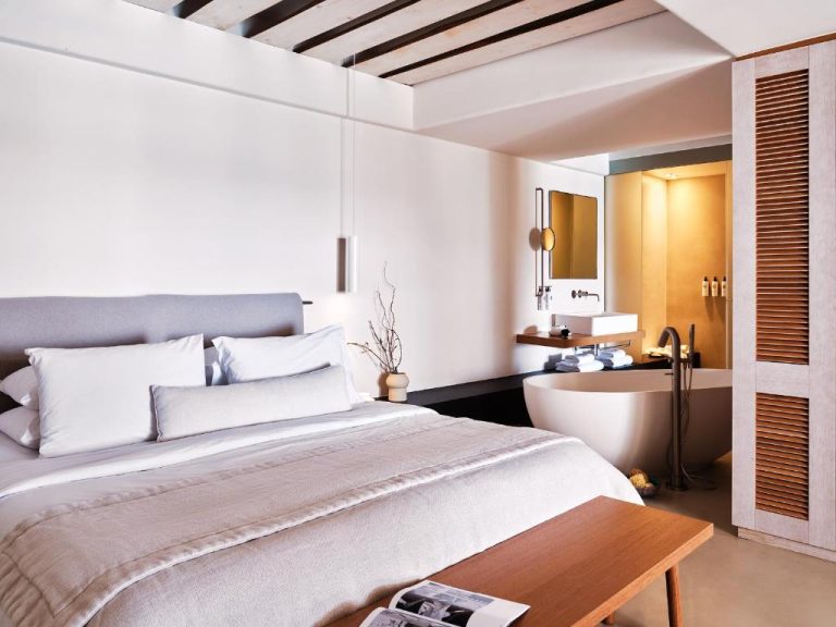 a bedroom with a large bed and a bath tub at BillCoo Mykonos The Leading Hotels of the World in Mikonos 768x576