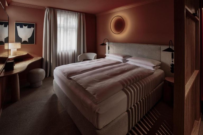 a bedroom with a large bed and a desk at ADELANTE Boutique Hotel in Berlin 768x514