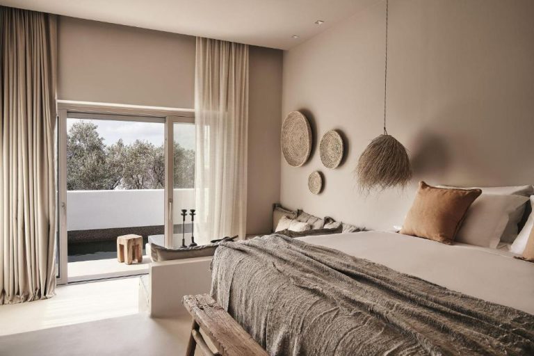 a bedroom with a large bed and a window at Amyth of Mykonos Agios Stefanos in Agios Stefanos 768x512