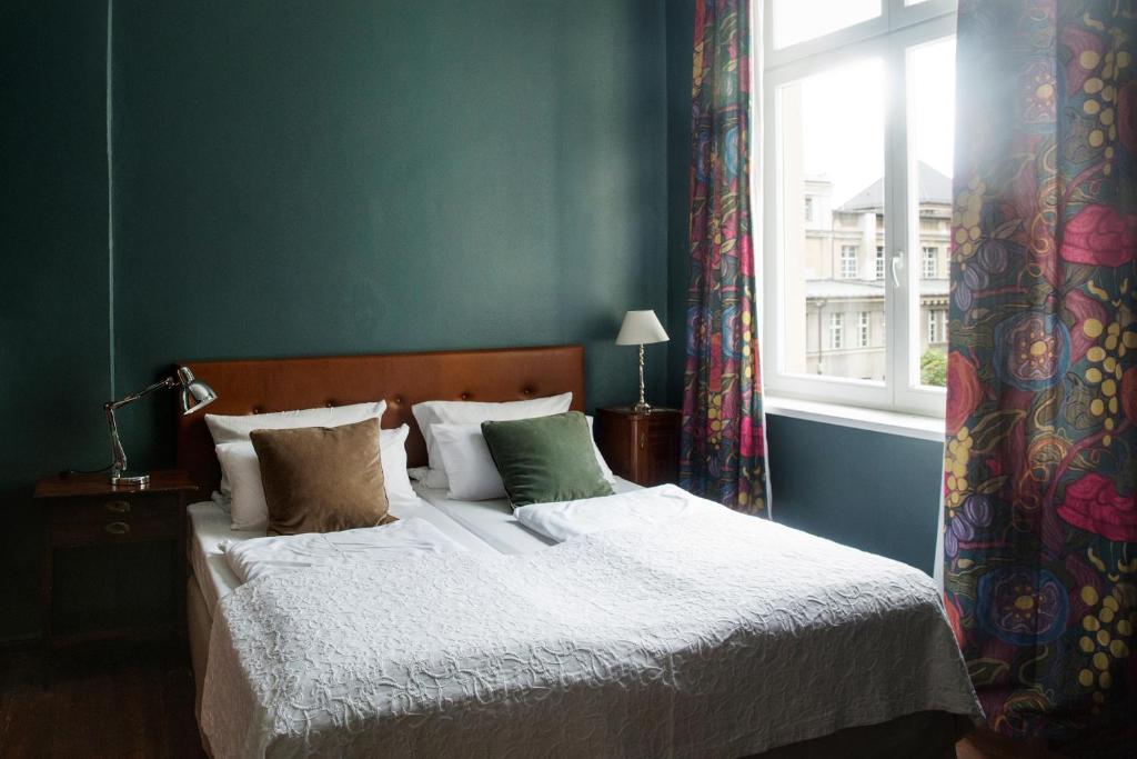 a bedroom with a large bed with a window at Hotel Art Nouveau am Kurfurstendamm in Berlin