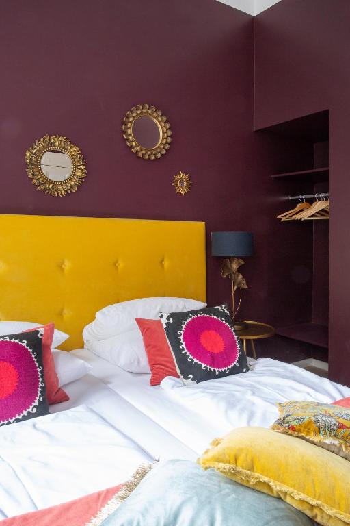 a bedroom with a large bed with a yellow headboard at Hotel Art Nouveau am Kurfurstendamm in Berlin