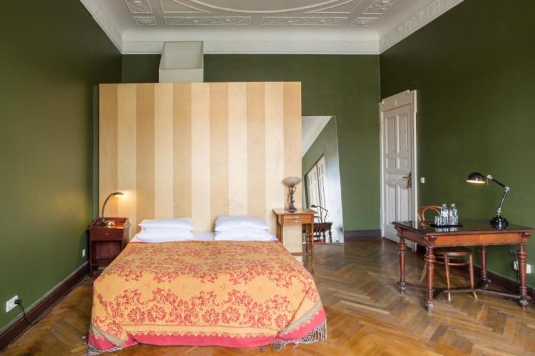 a bedroom with a large bed with green walls at Hotel Art Nouveau am Kurfurstendamm in Berlin 768x512