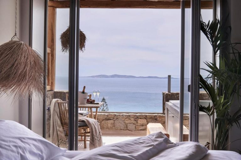 a bedroom with a view of the ocean at Amyth of Mykonos Agios Stefanos in Agios Stefanos 768x512