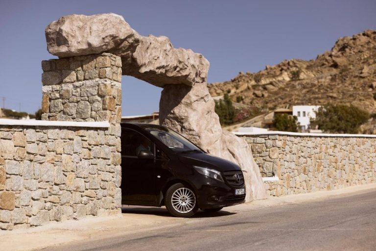 a black car parked next to a stone wall at Ethereum Luxury Suites a member of Mykonos Highlights in Mikonos 768x512