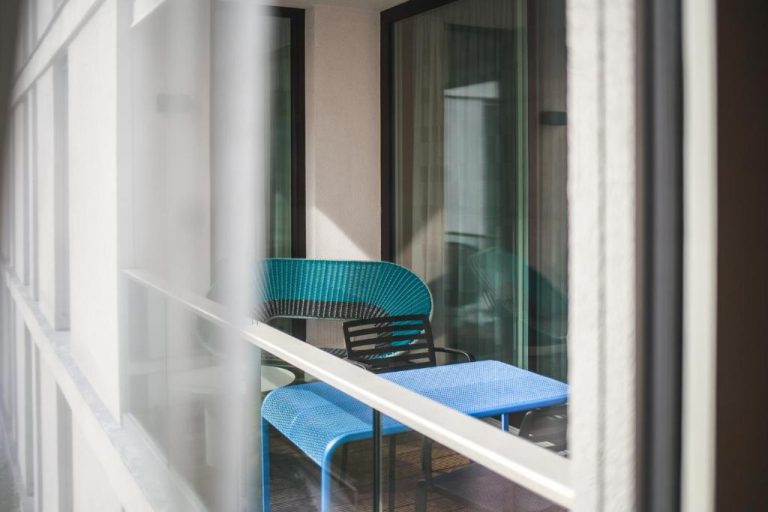 a blue table and chairs on a balcony at The Circus Apartments in Berlin 768x512