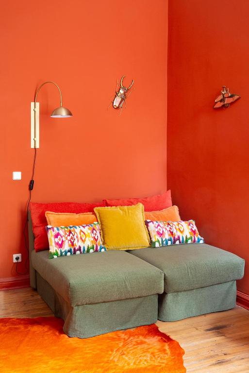 a couch with colorful pillows in a room at Hotel Art Nouveau am Kurfurstendamm in Berlin