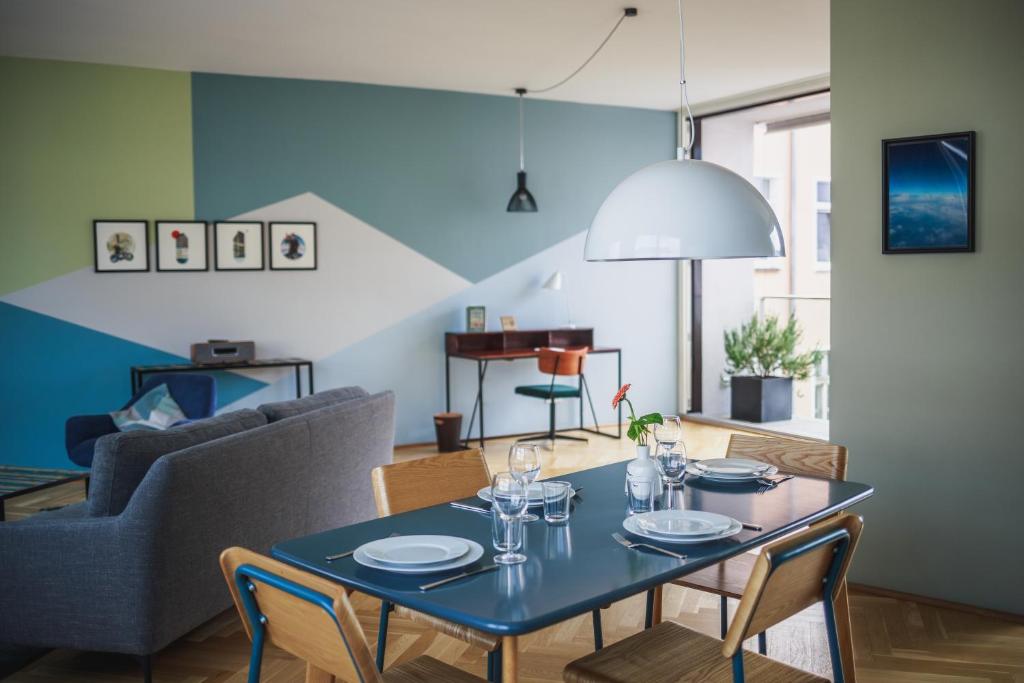a dining room with a blue table and chairs at The Circus Apartments in Berlin