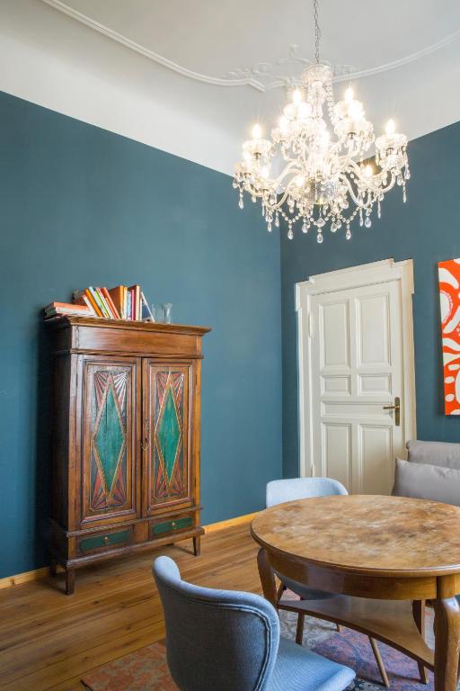 a dining room with a table and a chandelier at Hotel Art Nouveau am Kurfurstendamm in Berlin