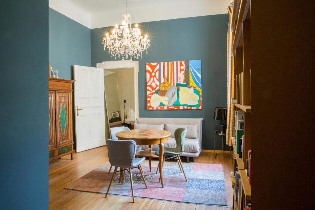 a dining room with a table and chairs and a chandelier at Hotel Art Nouveau am Kurfurstendamm in Berlin
