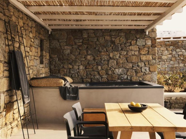 a dining room with a table and chairs at Boheme Mykonos Town Small Luxury Hotels of the World in Mikonos 768x575