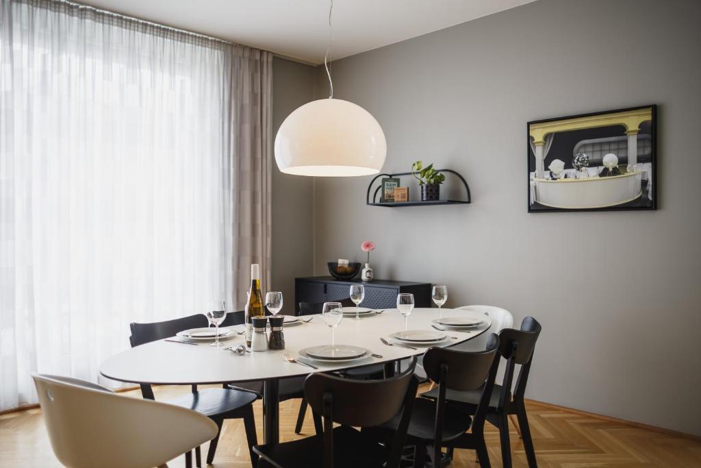 a dining room with a white table and chairs at The Circus Apartments in Berlin