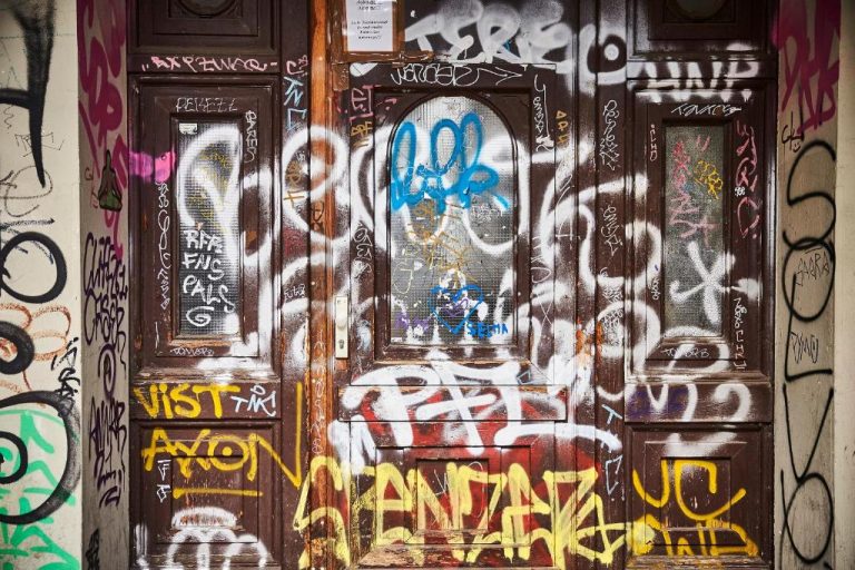a door covered in graffiti with graffiti on it at Orania.Berlin in Berlin 768x512