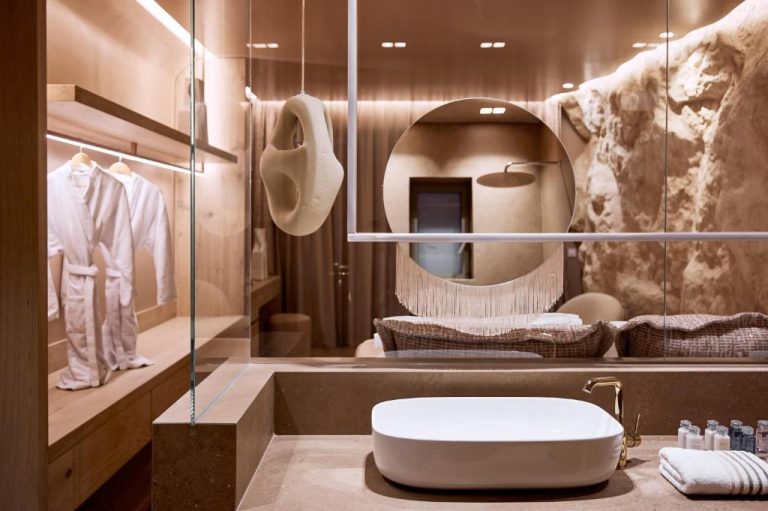 a dressing room with a large mirror and a sink at Ethereum Luxury Suites a member of Mykonos Highlights in Mikonos 768x511
