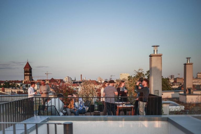 a group of people standing on top of a roof at The Circus Apartments in Berlin 768x512