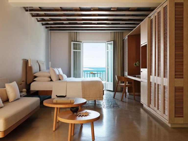 a hotel room with a bed and a couch at BillCoo Mykonos The Leading Hotels of the World in Mikonos 768x576