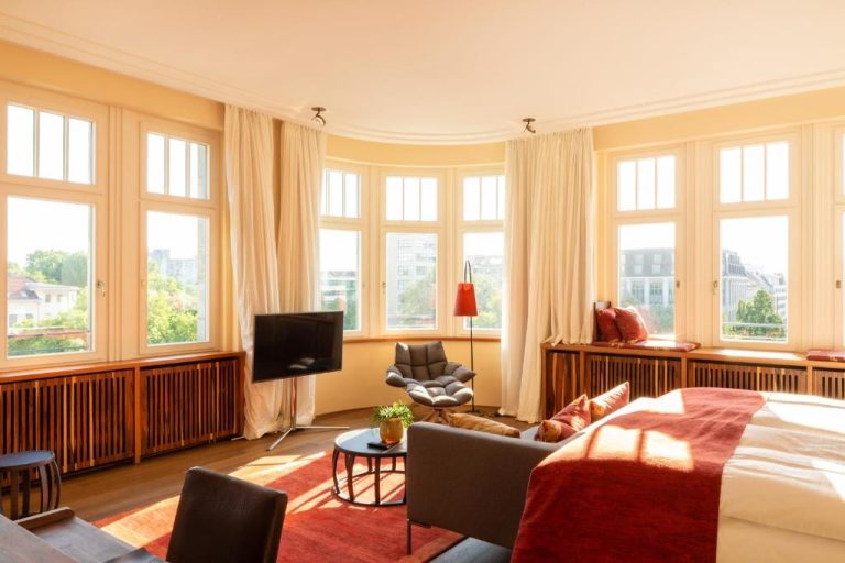 a hotel room with a bed and a tv at Orania.Berlin in Berlin 768x512