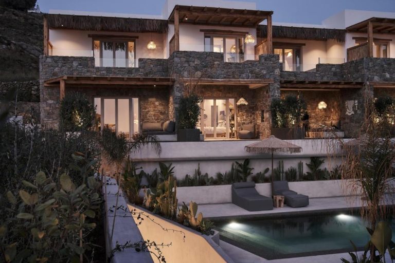 a house with a swimming pool in front of it at Amyth of Mykonos Agios Stefanos in Agios Stefanos 768x512