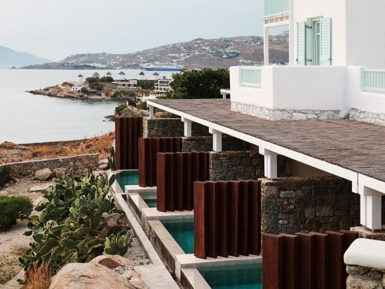a house with a swimming pool next to the water at BillCoo Mykonos The Leading Hotels of the World in Mikonos 768x576