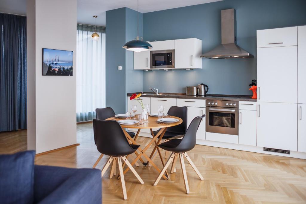 a kitchen and dining room with a table and chairs at The Circus Apartments in Berlin 1