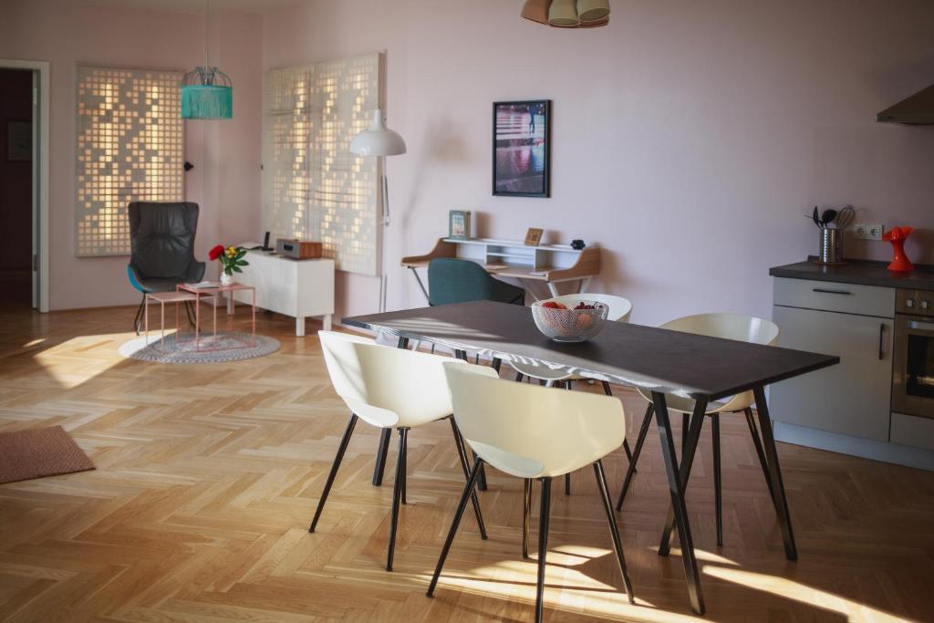 a kitchen and dining room with a table and chairs at The Circus Apartments in Berlin