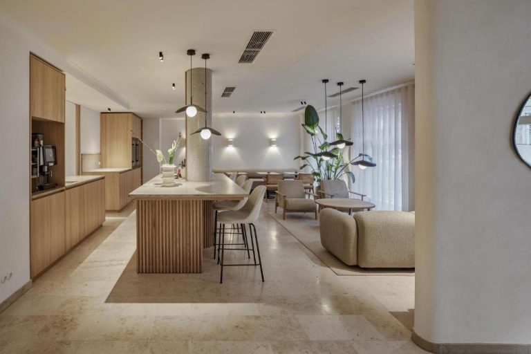 a kitchen and living room with a table and chairs at ADELANTE Boutique Hotel in Berlin 768x512