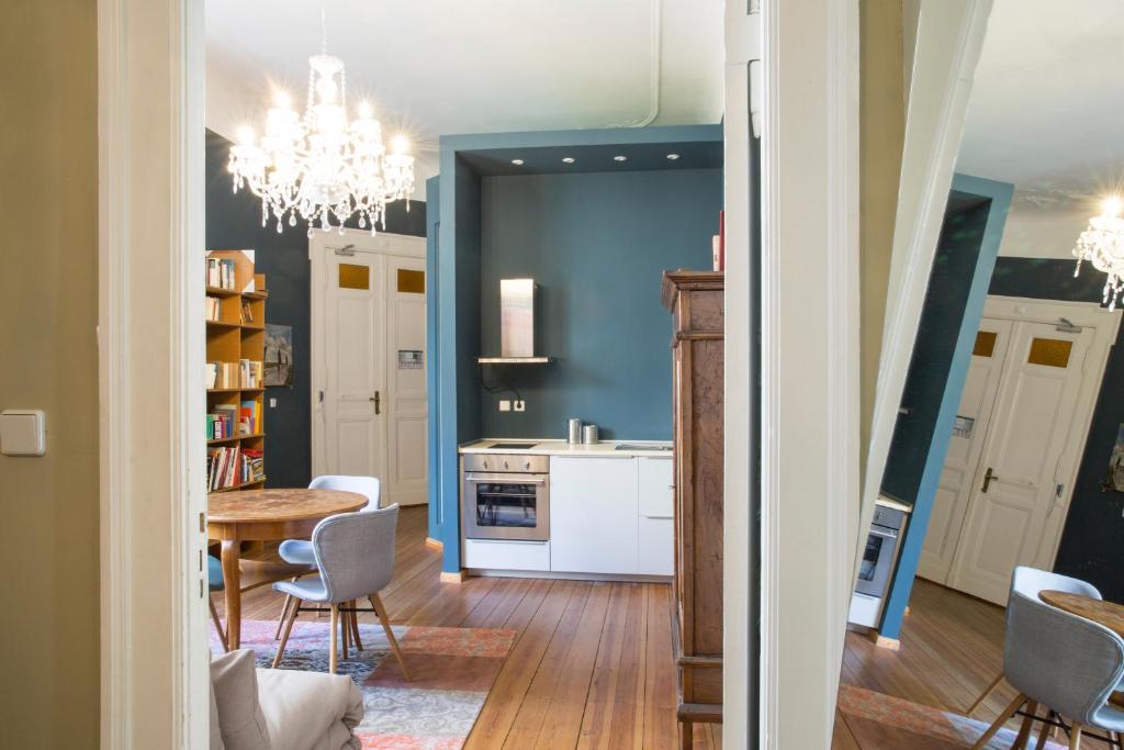 a kitchen with a table and a dining room at Hotel Art Nouveau am Kurfurstendamm in Berlin