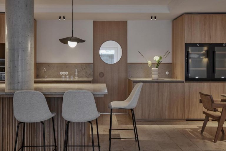 a kitchen with white chairs and a counter with a microwave at ADELANTE Boutique Hotel in Berlin 768x512