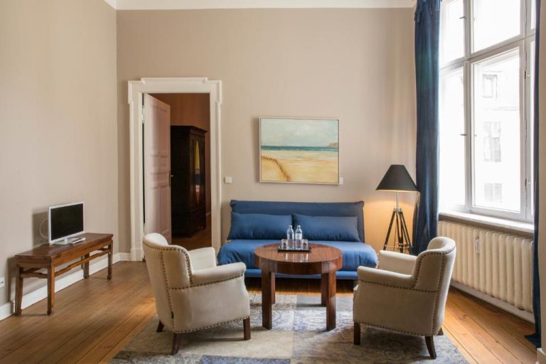 a living room with a blue couch and chairs at Hotel Art Nouveau am Kurfurstendamm in Berlin 768x512