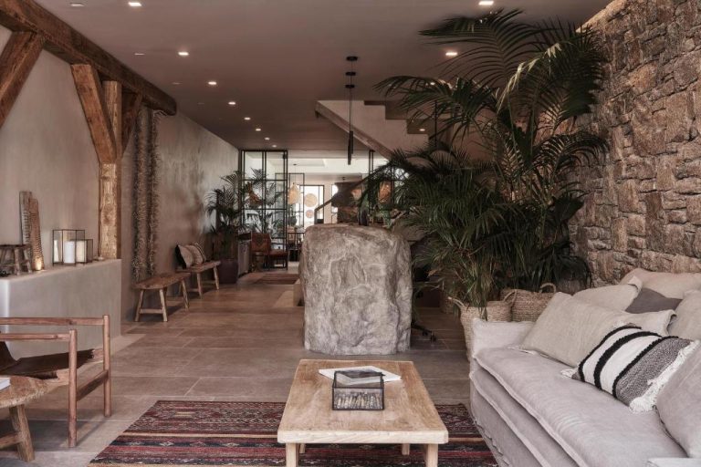 a living room with a couch and a table at Amyth of Mykonos Agios Stefanos in Agios Stefanos 1 768x512