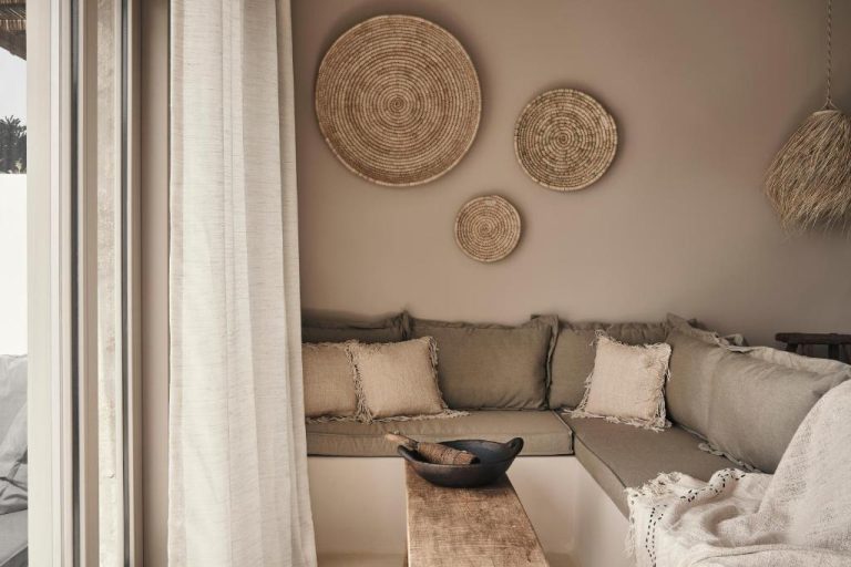 a living room with a couch and a table at Amyth of Mykonos Agios Stefanos in Agios Stefanos 768x512