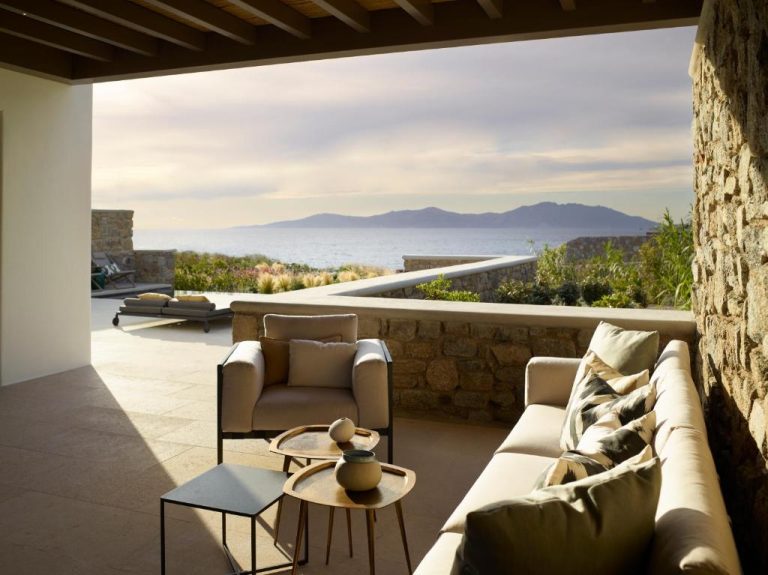 a living room with a couch and a table at Bonzoe Suites Villas in Mikonos 1 768x575