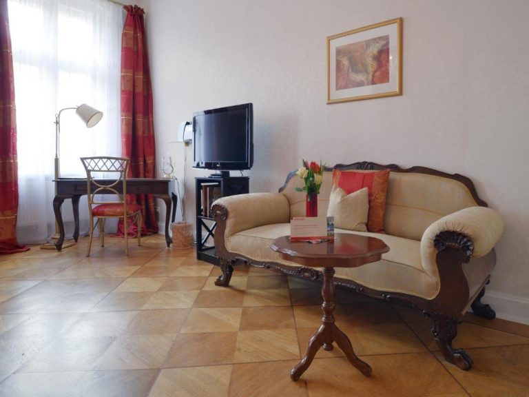 a living room with a couch and a table at Boutique Hotel Mittendrin Berlin in Berlin 1 768x576