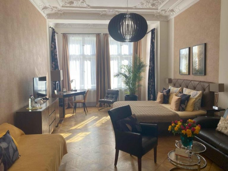 a living room with a couch and a table at Boutique Hotel Mittendrin Berlin in Berlin 768x576