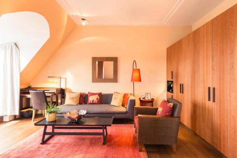 a living room with a couch and a table at Orania.Berlin in Berlin 1 768x512