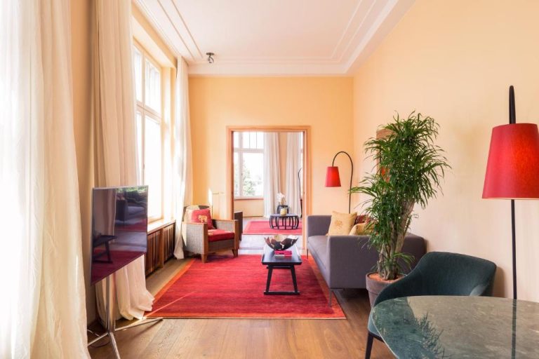 a living room with a couch and a table at Orania.Berlin in Berlin 768x512